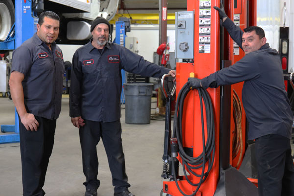 UTX Technicians at Vehicle Lift